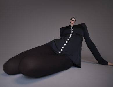A figure lounges in an unusual pose, wearing a black outfit with a series of bright buttons running down the front. The body is exaggerated and elongated, creating a surreal effect. Sunglasses accentuate the avant-garde appearance, while the high fashion style contrasts with the contorted, artistic presentation against a muted background.