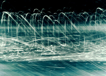 White, flowing lines create an abstract pattern against a dark backdrop. The lines swoop and curve in various directions, resembling waves or light trails. The overall effect is dynamic and energetic, with the intertwining paths forming a complex, layered texture. Some areas exhibit a sense of depth and movement, adding to the composition's striking visual impact.