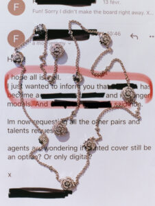 A delicate, gold chain with ornate, flower-shaped pendants is gracefully draped across a background with partially obscured text. The elegant chain and floral designs shine brightly, contrasting with the darker elements around them. The lines of text beneath appear partially redacted, emphasizing the intricate jewelry as the focal point against the blurred textual backdrop.