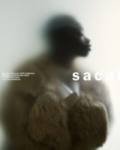 A stylized, blurred silhouette of a person facing left, enveloped in textured, voluminous fur or faux fur clothing. The background is softly lit, creating a dreamy and abstract atmosphere. The soft focus adds a sense of mystery and elegance to the scene, emphasizing the luxurious material and the contemplative pose of the figure.