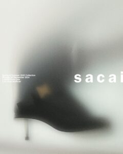 A blurred, artistic composition features a high-heeled shoe in a soft focus against a pale backdrop. The shoe has a sleek design with a pronounced heel, reflecting minimalist elegance. The overall tone is muted, creating a mysterious and sophisticated atmosphere. The gentle blending of colors emphasizes an avant-garde and fashion-forward aesthetic.